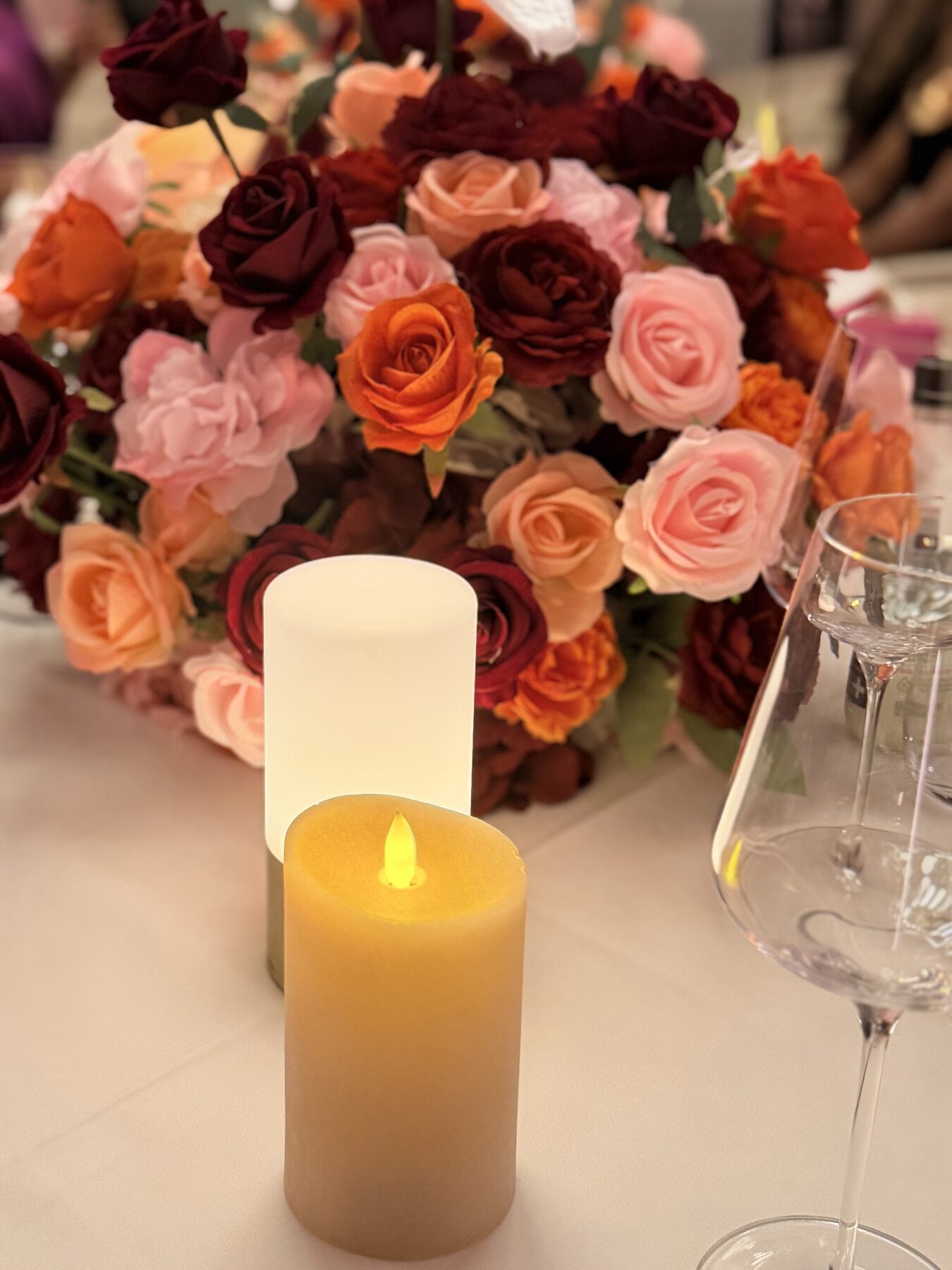 Jewel-toned rose centerpiece with white anthurium