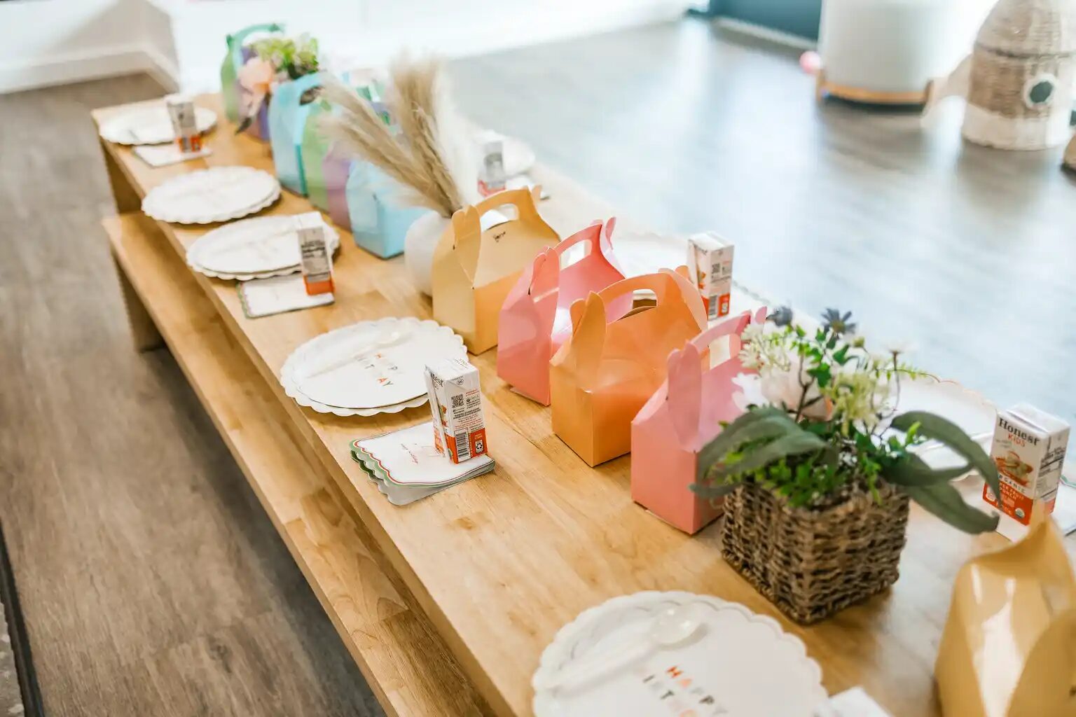 Pastel favor boxes styled with fresh florals for a kids party
